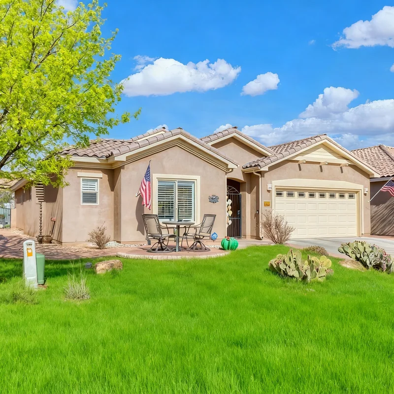 Lay green grass in front of the house, and replace the tree with one that has leaves as if it is spring.