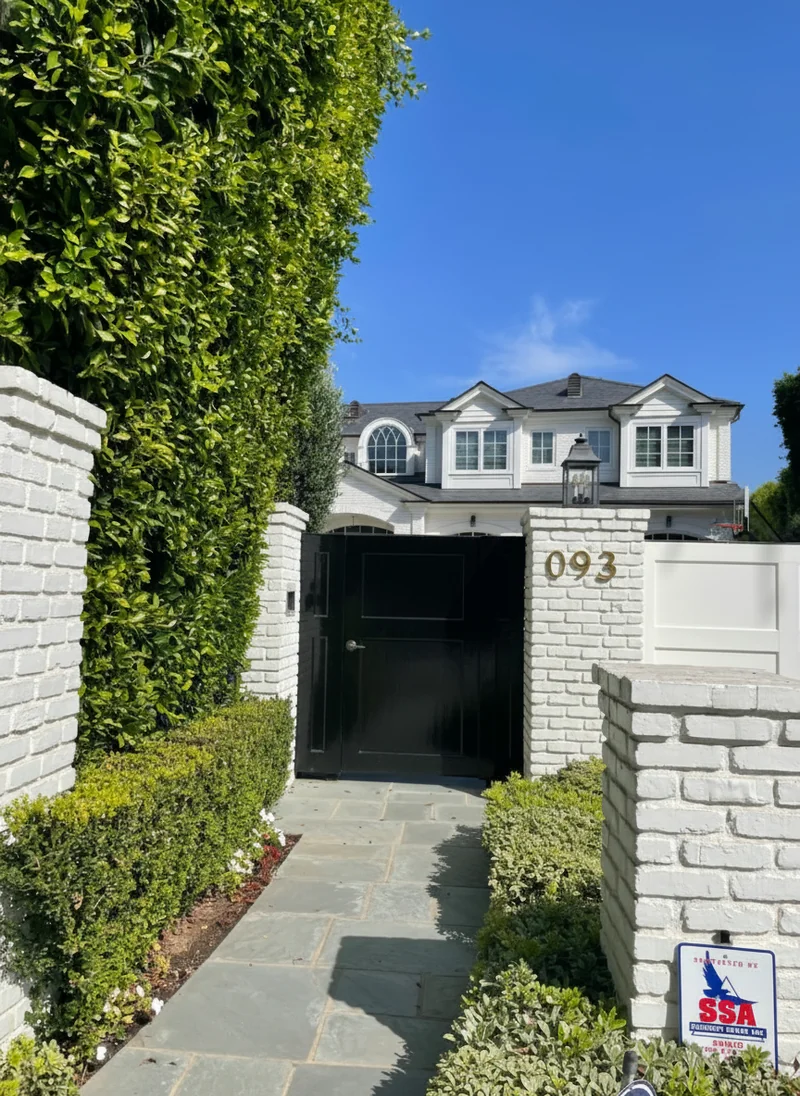 Change the white door to a black oil painted door, and set of golden letters with house number 093 on the brick wall on th...