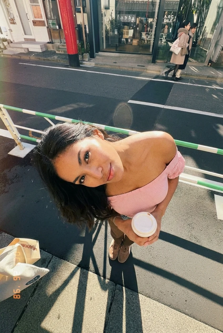 Create a photo of the woman in image 1, but in the camera composition and film photo filter style from image 2, with the woman on the street from image 2 with her head tilted side ways, in a phone camera style with soft grains, 90s photo style, shot in the same angle and fov as image 2