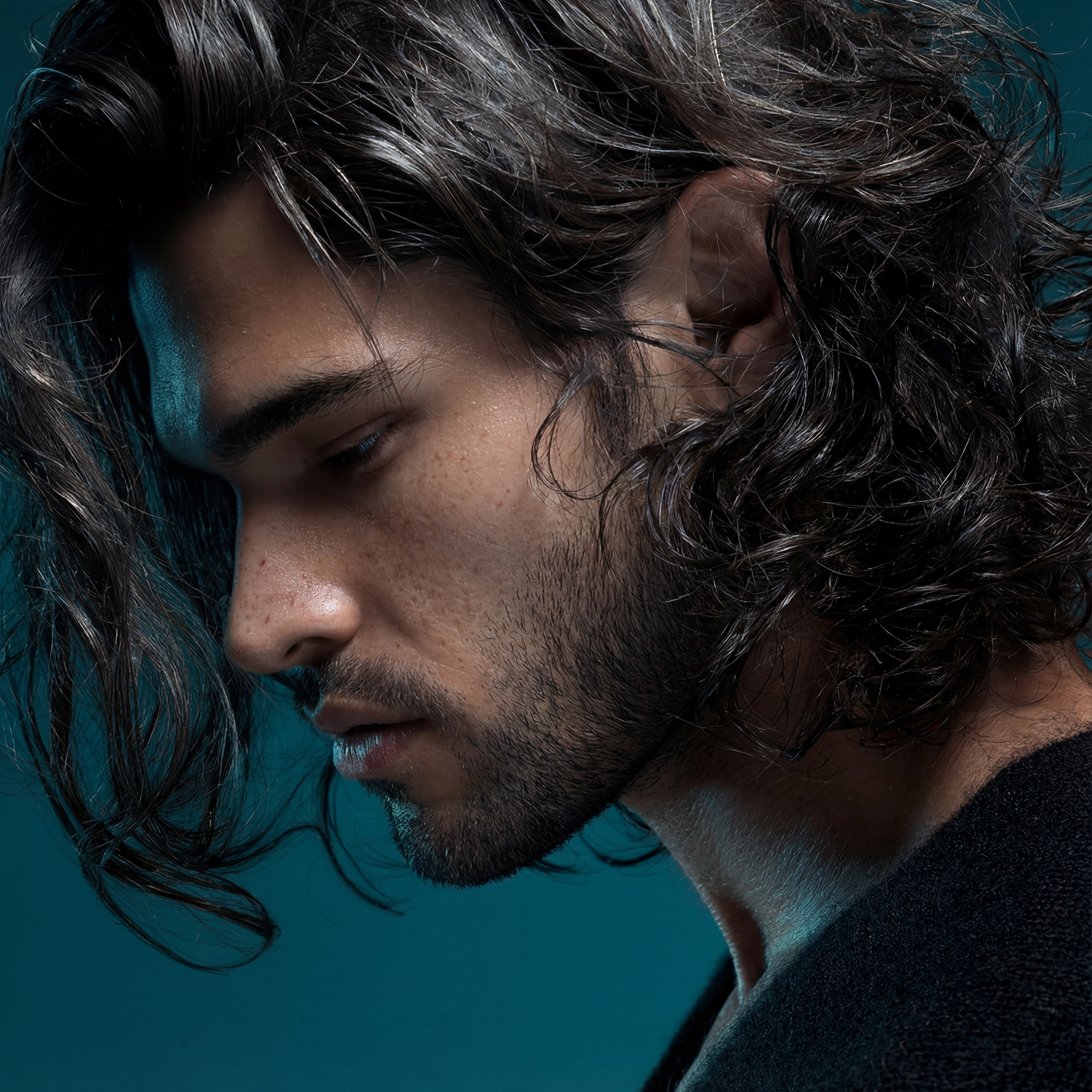 Enhance and upscale the image while keeping composition and colors identical. Eliminate blur and give the skin a lifelike, detailed look: faint fine lines, light freckles, and realistic transitions between shadow and highlight. Maintain the tone of the light and the background, refine edge sharpness on the eyes, lashes and hair strands so the portrait appears like a high-end portrait photograph with natural, unplastic skin.